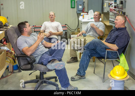Engineers sitting to an electric power plant Stock Photo