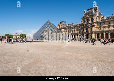 Paris, France - 23 June 2018: Louvre museum and Louvre Pyramid in summertime Stock Photo