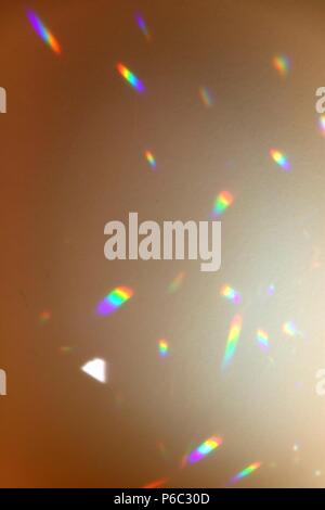 Photo of rainbow spots on beige wall. Stock Photo