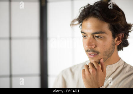 Close Up of Young Man Touching His Chin Stock Photo