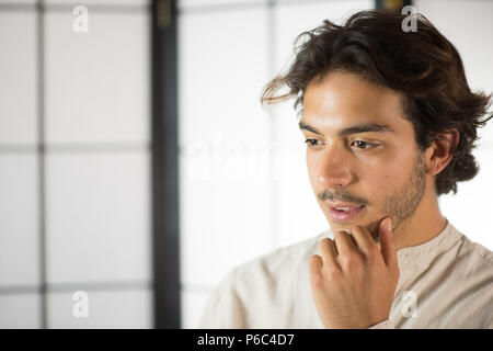Close Up of Young Man Touching His Chin Stock Photo