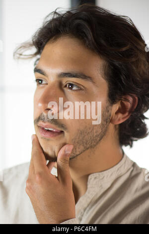 Close Up of Young Man Touching His Chin Stock Photo