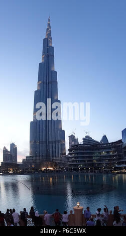 Dubai, United Arab Emirates, people in front of the Burj Khalifa at dusk Stock Photo