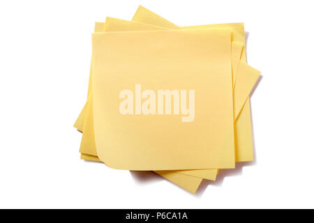 Untidy stack yellow sticky post notes isolated on white Stock Photo