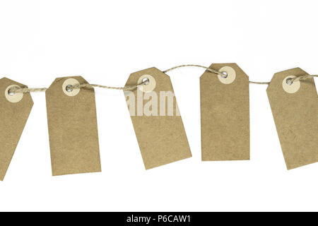 Blank brown note cards with copy space stuffed on brown rope like garland and isolated on white background Stock Photo