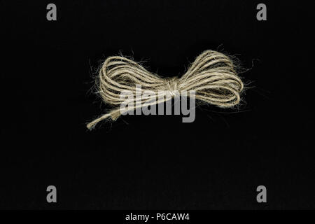 Ribbon from brown rope isolated on black background surface Stock Photo