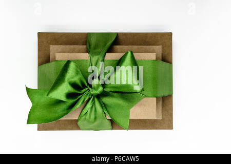 Three brown carton gift boxes bundled with green ribbon isolated on white background and view from above Stock Photo