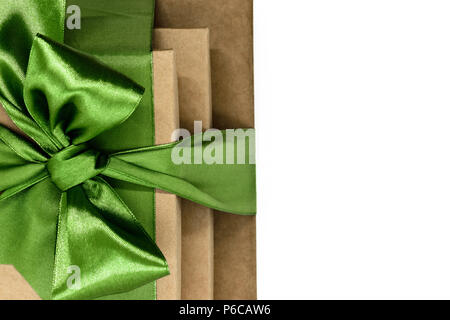 Three brown carton gift boxes bundled with green ribbon isolated on white background and view from above Stock Photo
