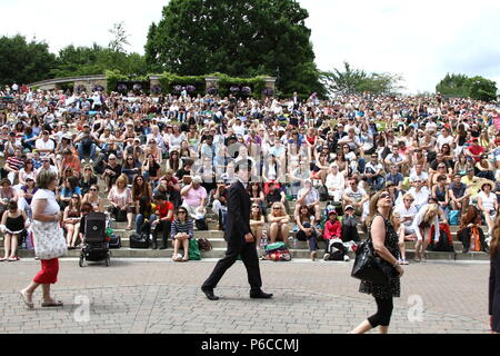 Front view of Henman Hill at the Wimbledon Lawn Tennis Championships with a focused crowd watching the big screen. Stock Photo