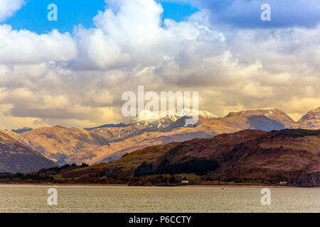 Snow on the summits of unidentified mountains viewed across Loch Linnhe from an Oban - Mull ferry, Argyll and Bute, Scotland, UK Stock Photo