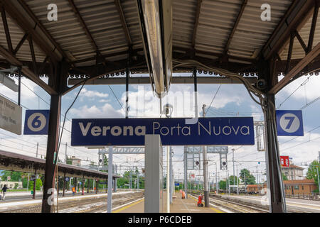 Verona, Italy train station platform. Porta Nuova main railway station with sign, tracks and platform view. Stock Photo