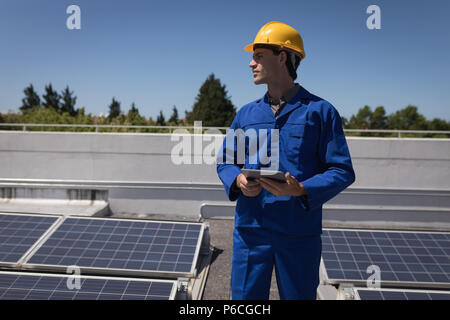 Male worker using digital tablet at solar station Stock Photo