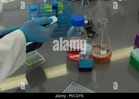 Scientist doing experiment in lab Stock Photo