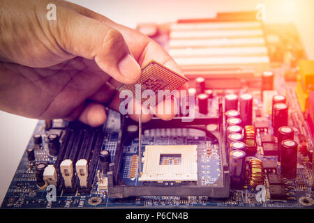 center of CPU, macro photography of cpu unit,man fixing computer by putting CPU on socket Stock Photo