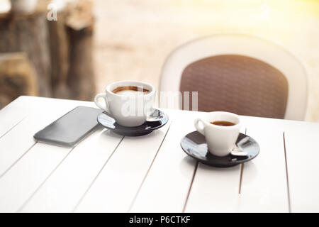 Breakfast for two in a cafe on the beach with two cups of coffee Stock Photo