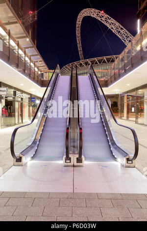 Escalators at Wembley Shopping centre with Stadium in the background. Stock Photo