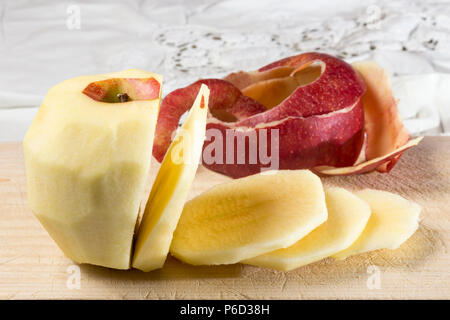 peeled and sliced apple on a wooden board Stock Photo