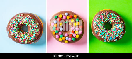 Pastries concept. Donuts with chocolate glaze, sprinkles, three, top view and isolated on blue, pink and green background. Stock Photo