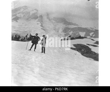 . English: Two men, Plummer and Holmes, on a snow slope in Paradise Park, Mount Rainier, August 1896 . English: Now located in Mount Rainier National Park which was established in 1899. PH Coll 35.161 Subjects (LCTGM): Mountains--Washington (State) Subjects (LCSH): Paradise Park (Wash.); Rainier, Mount (Wash.); Mountaineers--Washington (State)  . 1896 79 Two men, Plummer and Holmes, on a snow slope in Paradise Park, Mount Rainier, August 1896 (SARVANT 61) Stock Photo
