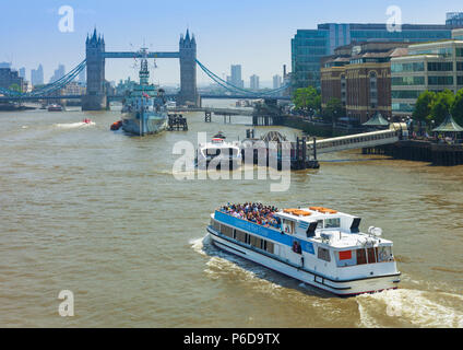 London eye river cruise boat on the river Thames approaching Tower bridge. Stock Photo
