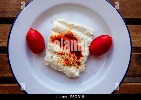 Greek Cuisine. Baked Feta Cheese with Dried Chilli and Cherry Tomatoes Stock Photo