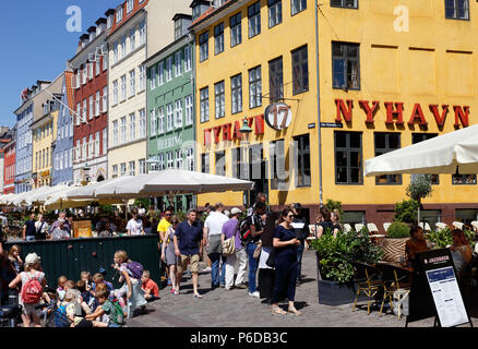 Copenhagen, Denmark - June 27, 2018: People in the Nyhavn district near the hotel and restaurant Nyhavn 17. Stock Photo