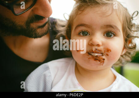 little girl enjoying a chocolate cake Stock Photo