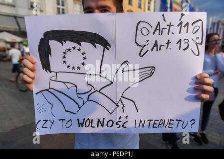 Krakow, Poland. 29th June, 2018. A man holds a banner saying 'is internet free ' during a protest against the implementation of ACTA 2 ( Anti Counterfeiting Trade Agreement) in European Union. On June 20th, The Legal Affairs Committee of the European Parliament approved the draft directive on copyright on the digital market. The next vote will take place on  July 4th. The European Commission intends to introduce a new tool, allegedly to protect copyrights. Credit: SOPA Images Limited/Alamy Live News Stock Photo