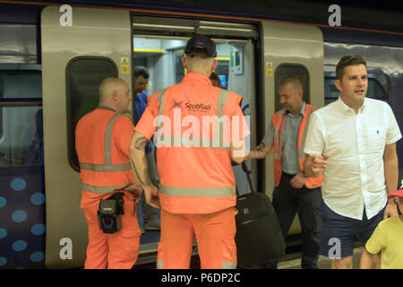 Glasgow, Scotland, UK. 29th June, 2018. A ScotRail train from Helensburgh Central to Edinburgh Waverley has broken down, after suffering brake failure and problems with its electronics systems. The incident happened in a tunnel, between Glasgow's Charing Cross and Queen Street, at about quarter past three on Friday. Engineers arrived quickly to organise a solution. Another train coupled up with the broken-down train and pushed it to Queen Street at a slower than usual speed. All passengers were detrained via the back doors shortly after 17:00. Iain McGuinness / Alamy Live News