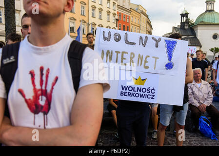 Krakow, Poland. 29th June, 2018. People hold a banner saying ''Free internet'' during a protest against the implementation of ACTA 2 ( Anti Counterfeiting Trade Agreement) in European Union. On June 20th, The Legal Affairs Committee of the European Parliament approved the draft directive on copyright on the digital market. The next vote will take place on July 4th. The European Commission intends to introduce a new tool, allegedly to protect copyrights. However, the treaty has a much broader scope and will deal with tools targeting internet distribution and information technology. (Credit I Stock Photo
