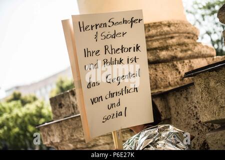 Munich, Bavaria, Germany. 30th June, 2018. A sign criticizing the Bavarian CSU for similar policies to the Trump administration. Joining widespread protests in cities across the United States, 100 ex-pats and Germans took to the streets of Germany to protest against the so-called Trump migrant family separations under the international banner of 'Families Belong Together''. Despite an executive order signed by President Trump putting an end to the practice, many families remain separated with countless children remaining in custody.In the timeframe of Oct 1, 2017 - May 31, 2018, at least Stock Photo