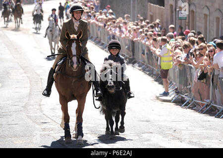 Galashiels, Scotland, UK, June 30:    Braw Lads' Day 2018 (Braw Lads Gathering) Mother and son, riding up Scott Street during the Braw Lads Gathering annual festival, part of the Scottish Common Riding season, on June 30, 2018 in Galashiels,  Credit: Rob Gray/Alamy Live News Stock Photo