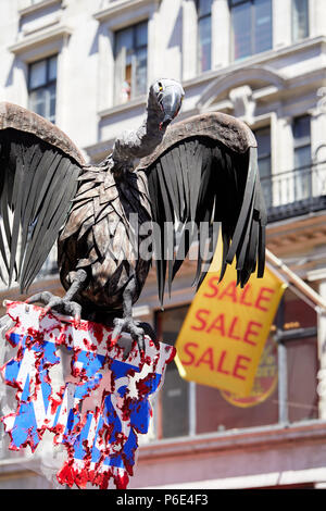 London, UK. 30 June 2018. A banner depicting a crow picking at a bloodied NHS sign in front of a 'Sale' flag during thhe NHS 70 Birthday March Credit: Kevin Frost/Alamy Live News Stock Photo