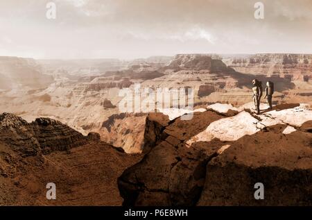 Illustration of the Valles Marineris canyon system, Mars, being surveyed by a pair of astronauts. The Valles Marineris is over 4000 kilometres (km) long, up to 200 km wide and up to 7 km deep, dwarfing the Grand Canyon of Arizona, USA. The canyons are found on the southeastern edge of the Tharsis Bulge and were originally created by faulting during the formation of Tharsis. The canyons have been further worn down by water and wind erosion. Finally, slumping has helped widen the canyon so that the bottom is visible from space. Stock Photo