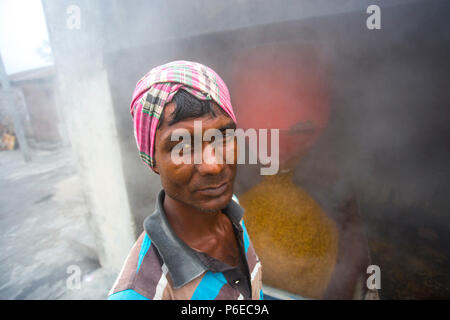 The processed rice is being brought out at Ishwardi Upazila, Pabna District in Rajshahi Division, Bangladesh. Stock Photo