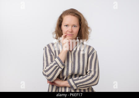 Middle aged european woman thinking and looking up, confused about an ide Stock Photo