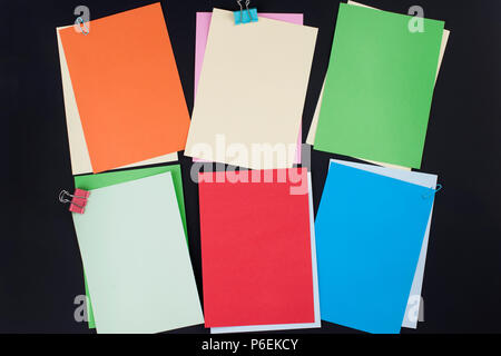 Many different colored papers for notes on a black background. Office concept. Copy space Stock Photo
