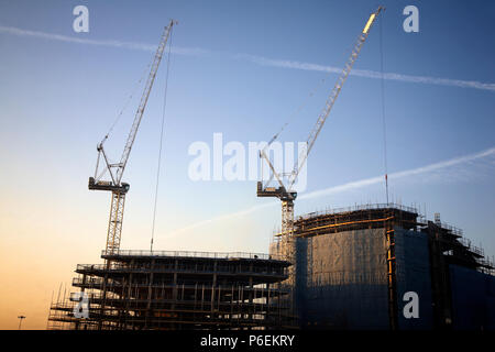 High rise crane seen here working construction building site in Leeds, Yorkshire Stock Photo
