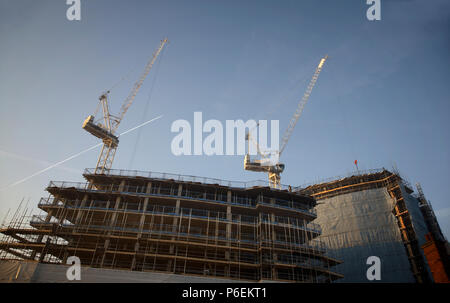 High rise crane seen here working construction building site in Leeds, Yorkshire Stock Photo