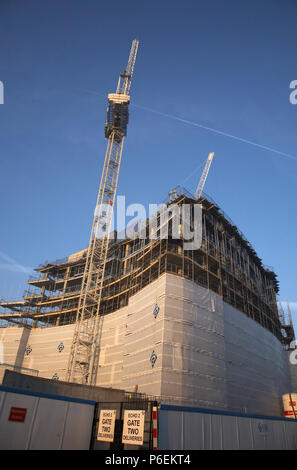 High rise crane seen here working construction building site in Leeds, Yorkshire Stock Photo