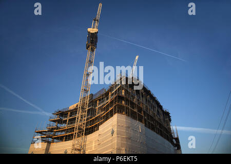 High rise crane seen here working construction building site in Leeds, Yorkshire Stock Photo