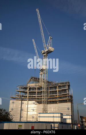 High rise crane seen here working construction building site in Leeds, Yorkshire Stock Photo
