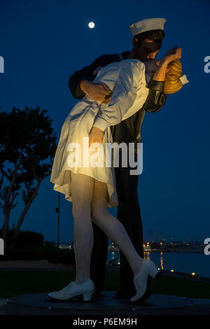 Moon over 'Unconditional Surrender' sculpture (sailor kissing a nurse), by Seward Johnson, San Diego, California USA Stock Photo