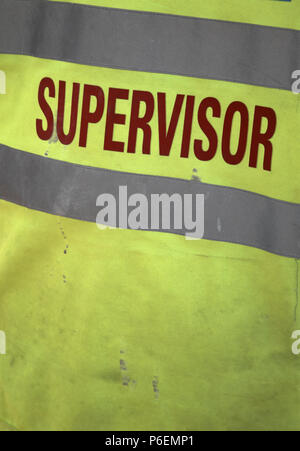 Supervisor wearing High Vis safety jacket on a working construction building site in Leeds, Yorkshire Stock Photo