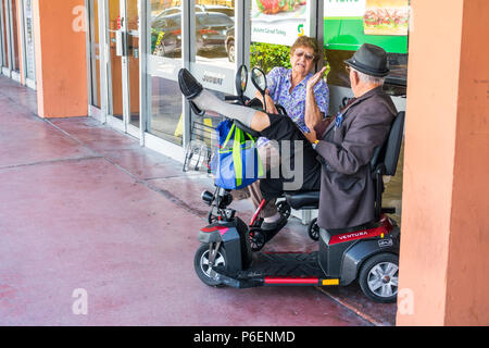 Miami Beach Florida,Hispanic senior seniors citizen citizens,man men male,woman female women,retiree,electric cart wheelchair,mobility scooter,disable Stock Photo