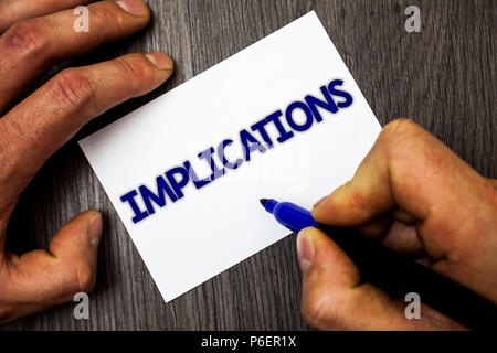 Conceptual hand writing showing Implications. Business photo showcasing Conclusion State of being involved Suggestion Insinuation Hint Man working hol Stock Photo