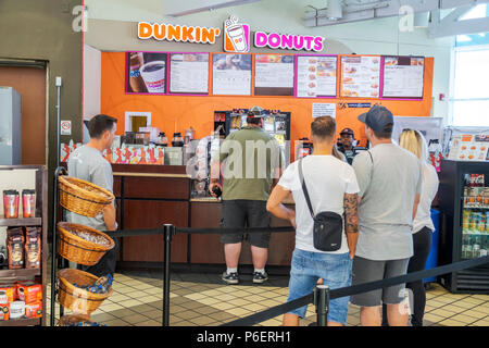 Florida,Fort Ft. Pierce,Florida's Turnpike toll road,rest stop,Dunkin' Donuts,coffee,counter,adult adults man men male,line,queue,visitors travel trav Stock Photo