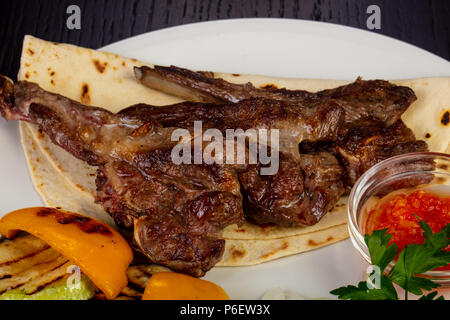Delicious fried lamb loin with pita and roasted pepper Stock Photo - Alamy