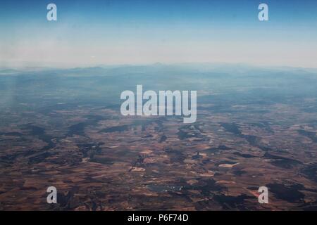 Aerial photography - Landscapes. Clouds and mist hundreds of thousands of feet above with land far below. Stock Photo