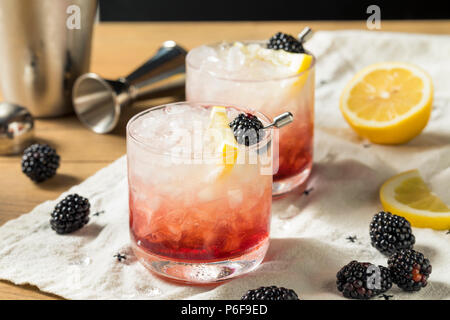 Alcoholic Blackberry Gin Bramble Cocktail with Lemon Stock Photo